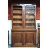 A Victorian mahogany bookcase with moulded cornice over pair of glazed doors (one def) over pair