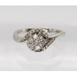 An 18ct white gold diamond flower ring (two diamonds missing) set with estimated approx 0.25cts,