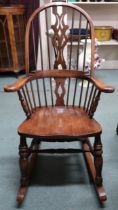 A 20th century elm Windsor style rocking chair, 119cm high  Condition Report:Available upon request