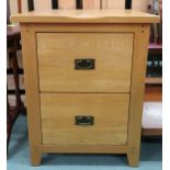 A contemporary teak two drawer filing cabinet, 79cm high x 63cm wide x 53cm deep Condition Report: