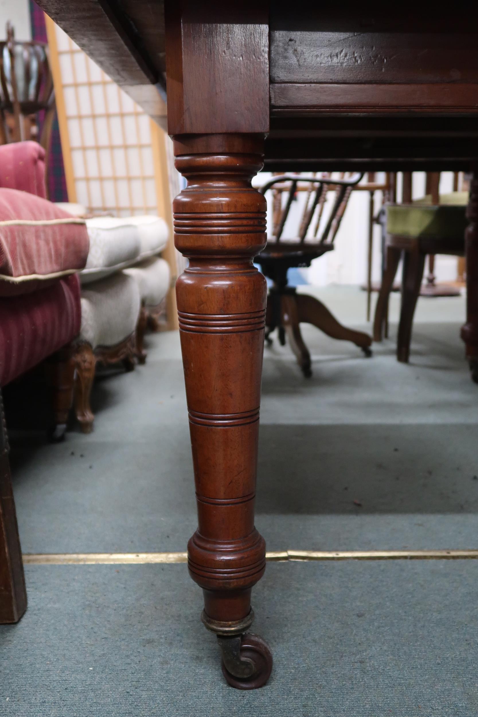 A Victorian mahogany wind out extending dining table on turned supports terminating in ceramic - Image 4 of 7