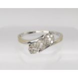 An 18ct gold diamond three flower ring, set with estimated approx 0.25cts of brilliant cuts,