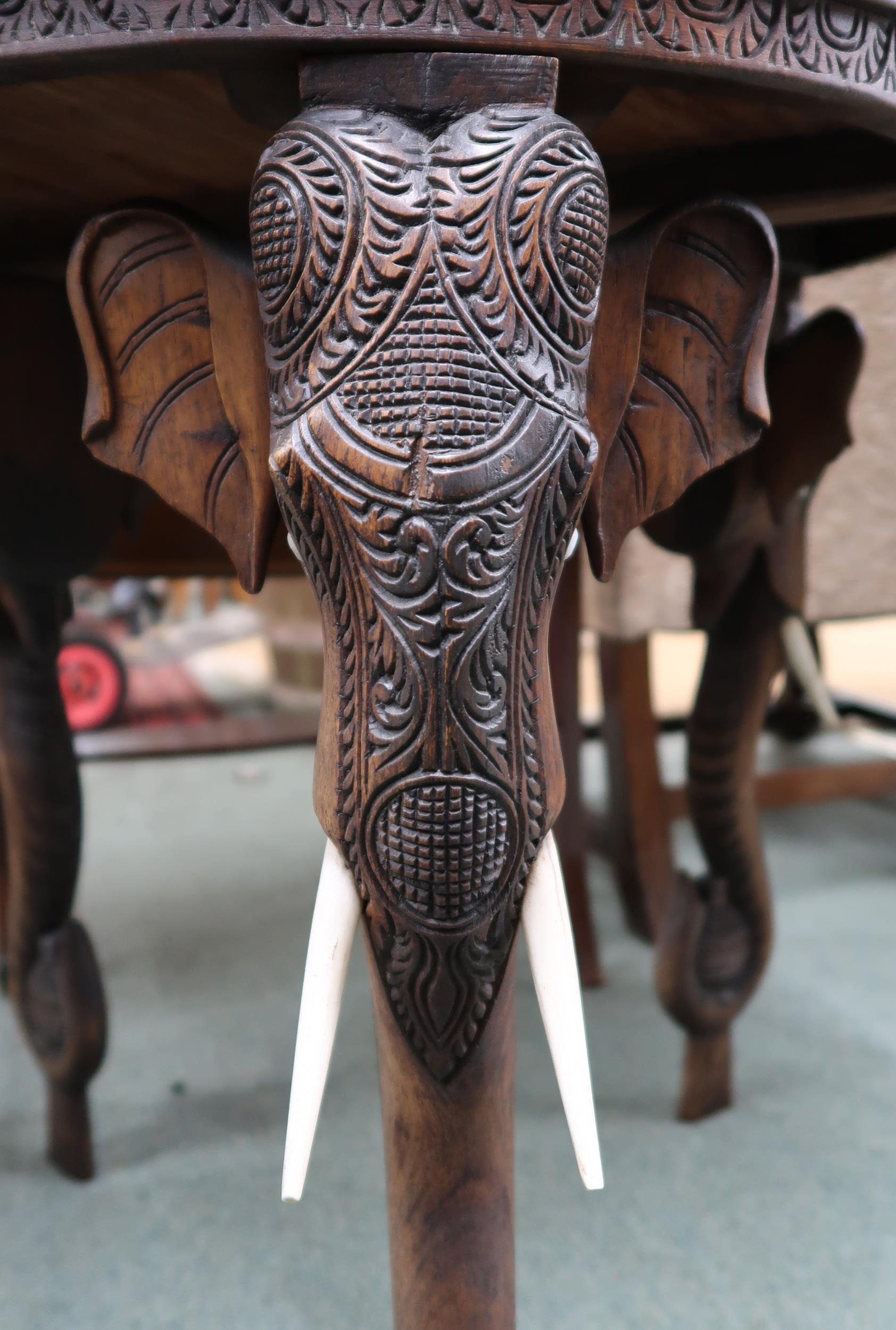 An early 20th century hardwood "elephant" table with carved circular top on carved supports in the - Image 3 of 4