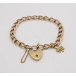 A 9ct rose gold curb link chain with heart shaped clasp and shamrock charm, length 17cm, weight 15.