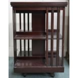 An early 20th century mahogany revolving bookcase with two tiers of bookshelves, 82cm high x 53cm