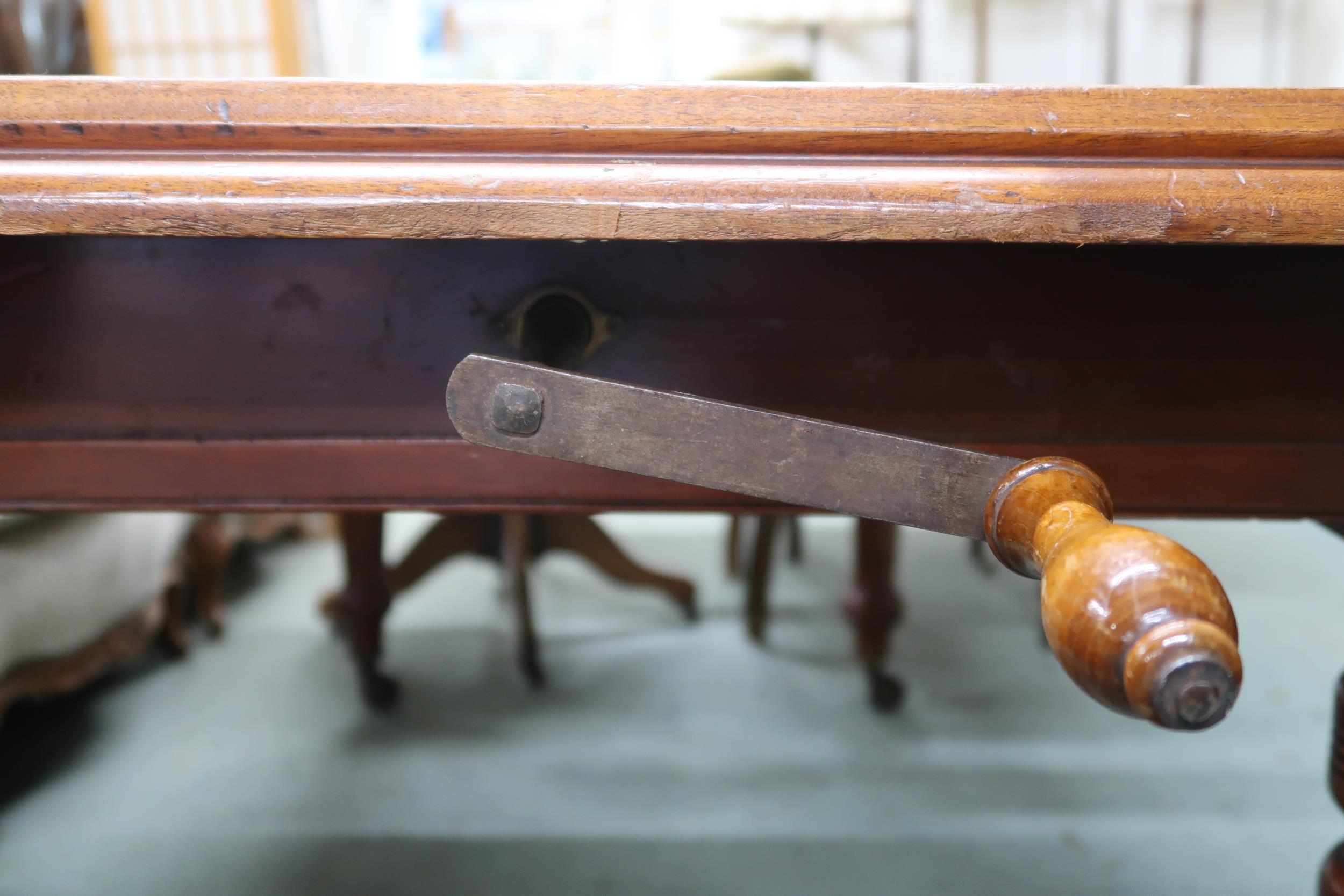 A Victorian mahogany wind out extending dining table on turned supports terminating in ceramic - Image 5 of 7