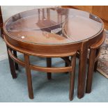 A mid 20th century teak Nathan circular glass topped nesting coffee table, 51cm high x 82cm diameter