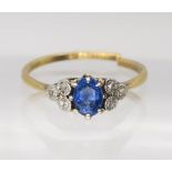 A bright yellow metal sapphire and diamond ring, the central sapphire is approx 5.5mm x 4.3mm x 2.