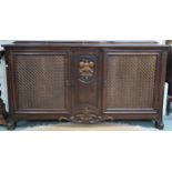 A 20th century mahogany reproduction cabinet with pair of doors with metallic wire lattice panel