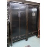 A pair 20th century black lacquer wardrobes with two doors over single drawer with brass hinged
