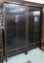 A pair 20th century black lacquer wardrobes with two doors over single drawer with brass hinged