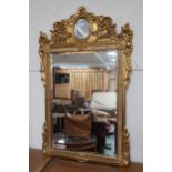 A 20th century gilt framed rococo style wall mirror, 125cm high x 78cm wide  Condition Report: