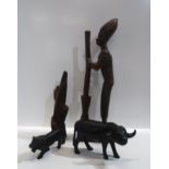 An African carved wooden figure, 43cm high, another of a water buffalo and a lion, and another