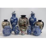 A matched pair of Chinese blue and white cracked ice pattern vases, the lids with fo dog finials,