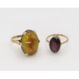 A 9ct gold garnet ring, size P, together with a 9ct amber ring size O, weight together 7.5gms