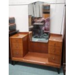 A 20th century teak mirror backed dressing table with central mirror flanked by banks of three