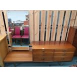 A mid 20th century teak mirror backed dressing table with mirror offset from three pairs of
