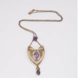 A 9ct gold, amethyst and pearl Edwardian pendant necklace, length of the winged pendant from the top