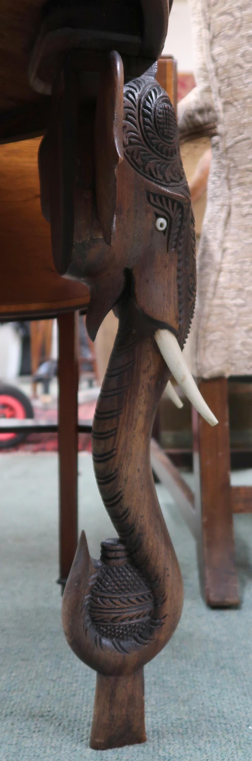 An early 20th century hardwood "elephant" table with carved circular top on carved supports in the - Image 4 of 4