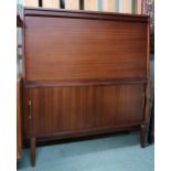 A mid 20th century stained teak bureau with fall front writing compartment over sliding doors, 101cm