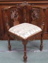 A 20th century walnut corner chair with shaped back over carved pierced splats joined to seat with