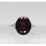 A yellow and white metal garnet ring, size J1/2, weight 2.8gms Condition Report:Available upon