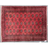 A red ground bokhara rug with all over lozenge design and multiple borders, 105cm long x 83cm wide