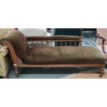 A Victorian oak framed chaise longue with green velour upholstered seat, scroll end and back rail on