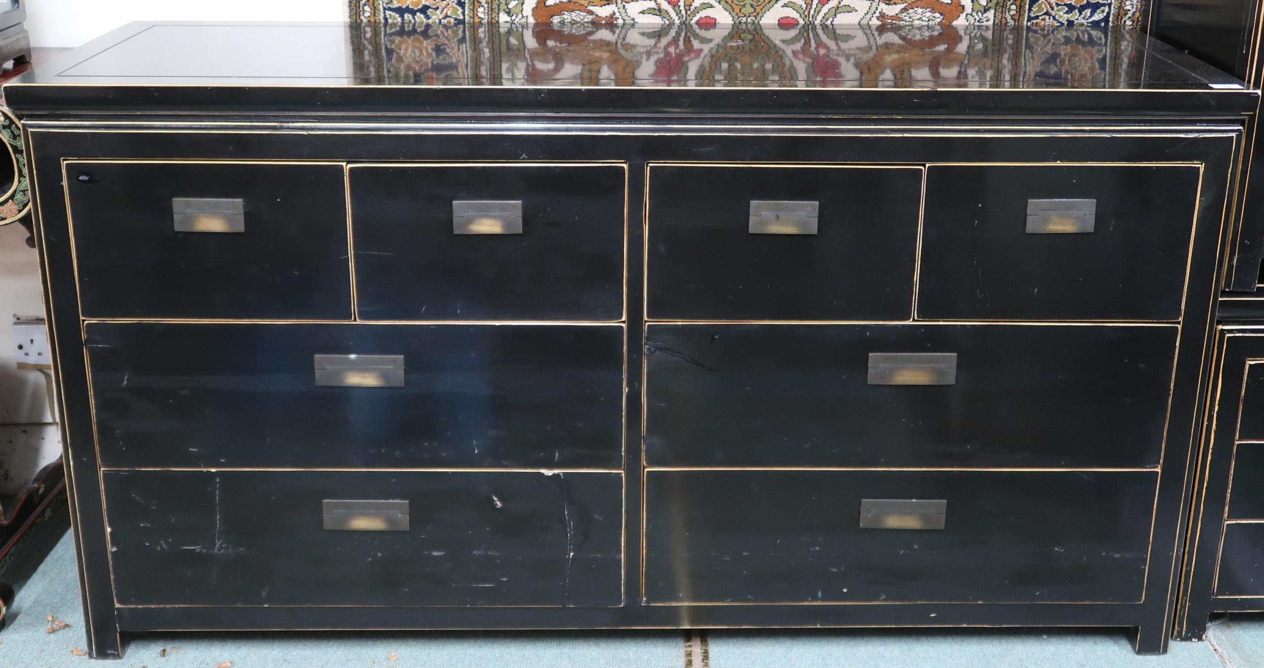 A 20th century black lacquer bank of drawers with four short over two pairs of long drawers with