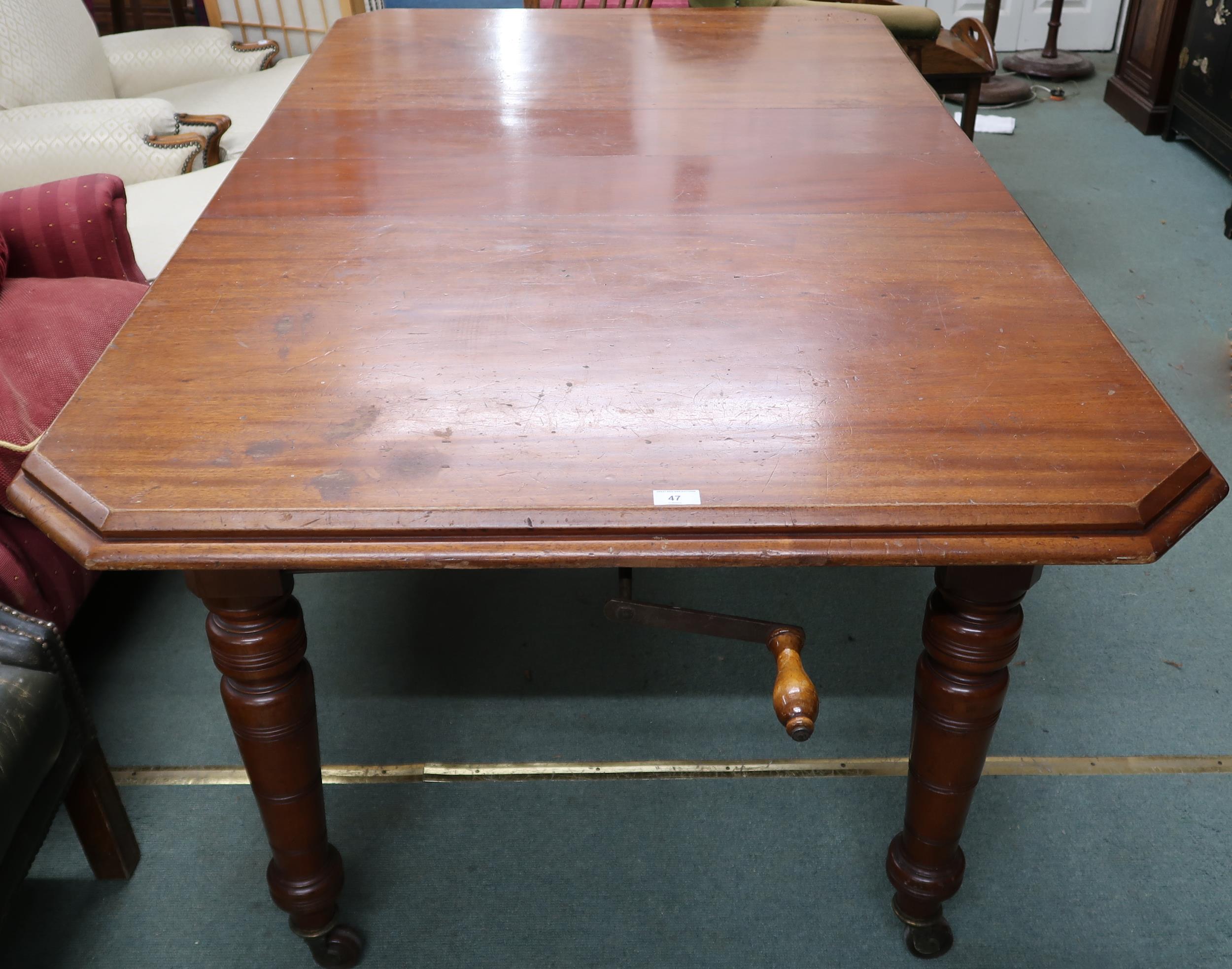 A Victorian mahogany wind out extending dining table on turned supports terminating in ceramic - Image 7 of 7