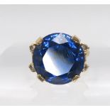 A 10k gold ring set with a large blue and four clear gems, size n, weight 7.5gms Condition Report: