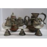 Three Nautilus shell bird handled vessels and a pair of copper and brass coffee pots Condition