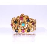 A bright yellow metal retro multi gem set ring, set with turquoise, rubies and sapphires etc, size