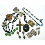 A gilded white metal cross set with jewel beetles, five green glass Max Neiger Pharaoh beads, a