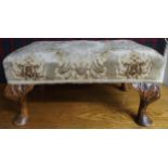 A 20th century upholstered footstool with cabriole supports carved with acanthus leaves, 28cm high x