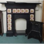A 19th century cast iron combination fireplace/insert with iron mantle over floral tile inset
