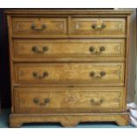 An early 20th century pitch pine two over three chest of drawers with cast brass drawer pulls on