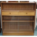 A mid 20th century teak bookcase with open shelf over two drawers over glass sliding doors, 108cm