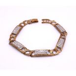 A 9ct gold curb link bracelet with clear gem set panels, length 20cm approx, weight 15.5gms