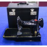 A Singer Featherweight Model 221K portable sewing machine, with original carry case and