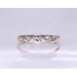 A bright yellow metal vintage five stone diamond ring, set with estimated approx 0.25cts of old