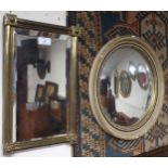 A Victorian brass framed bevelled glass rectangular mirror and a circular concave wall mirror (2)