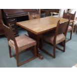 A 20th century French oak dining suite consisting refectory style pull out extending dining table