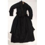 A Victorian black satin skirt bustle, bodice and collar, the inside edges of the material printed