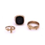 Three 9ct gold rings, cross size J1/2, buckle size U, onyx signet size Y1/2, weight together 10.6gms