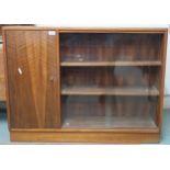 A mid 20th century teak bookcase with cabinet door alongside pair of glass sliding doors, 77cm