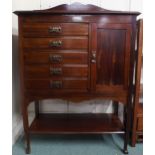An early 20th century mahogany Arts & Crafts music cabinet with five drawers alongside cabinet