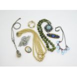 A string of Iona marble beads with silver clasp, a Thomas Mott, crinoline lady brooch, deco clips