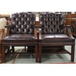 A pair of 20th century Georgian style button back leather upholstered armchairs, 94cm high x 63cm
