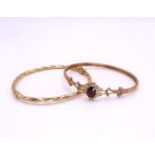 A 9ct gold garnet set bangle, together with a 9ct twist pattern bangle, weight together 9.8gms